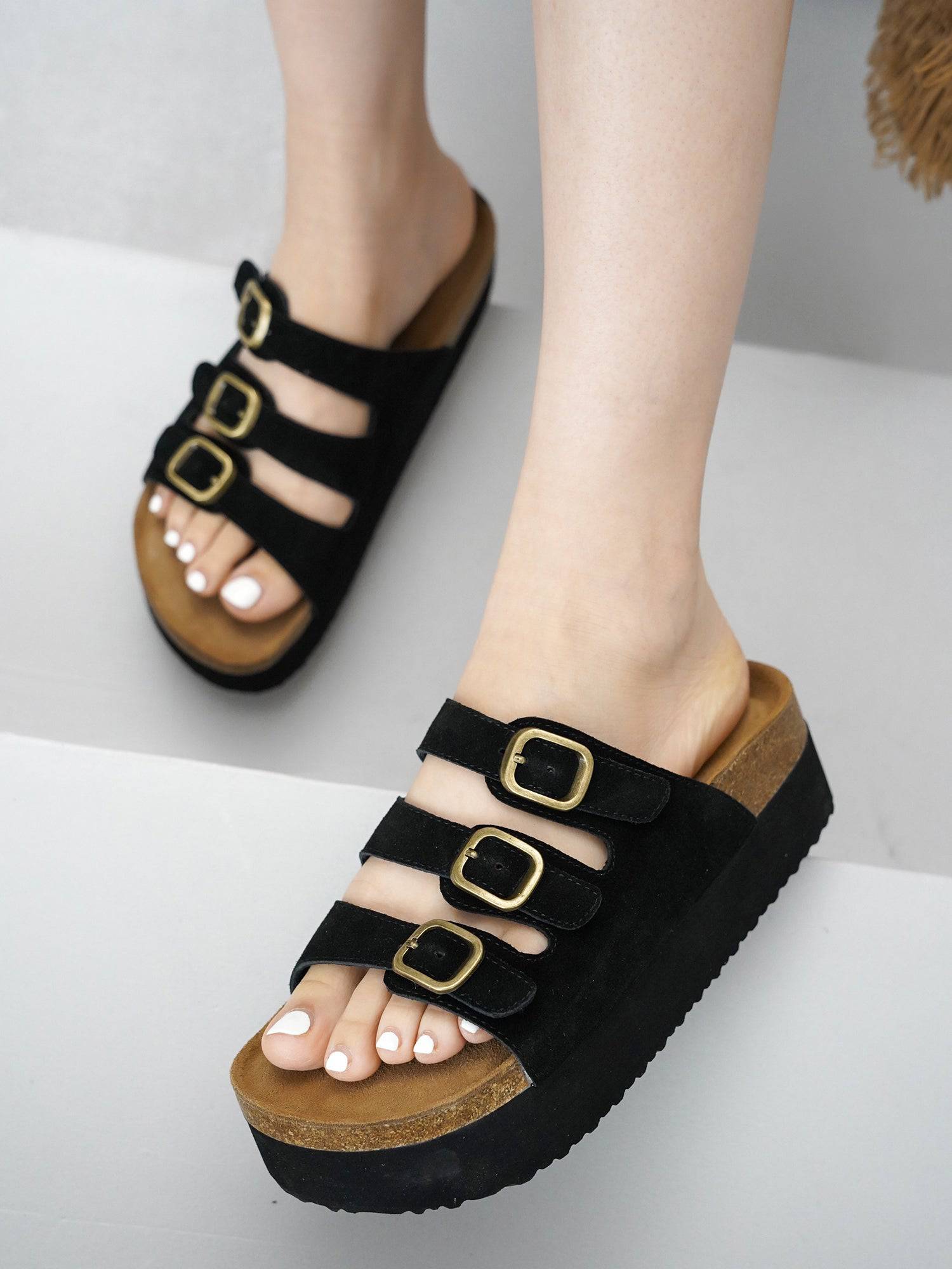 Project Cloud Dyan platform sandals in black suede. Three buckle straps, cork footbed, and non-slip sole for women.