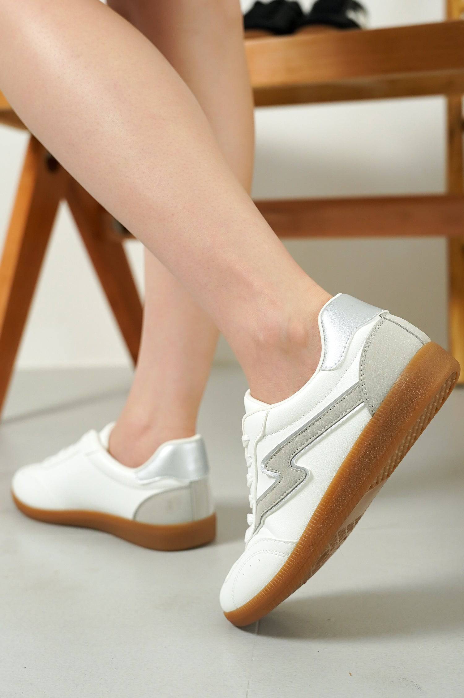 White Irita sneakers, lightning bolt design, brown sole. Women's lace-up Project Cloud shoes.