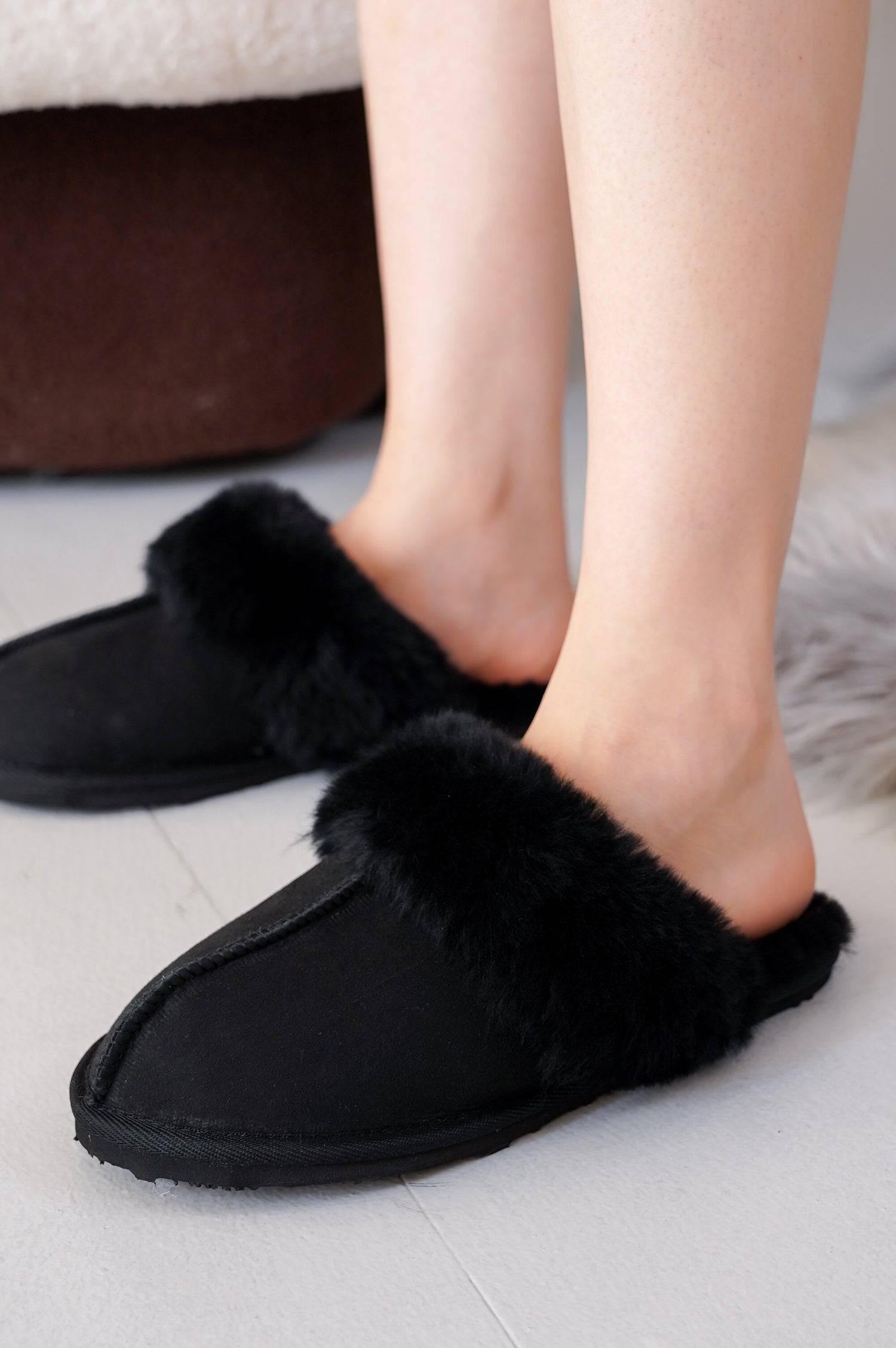 Project Cloud Lynsey slippers in black suede with sheepskin fur lining, memory foam and non-slip sole, showing feet