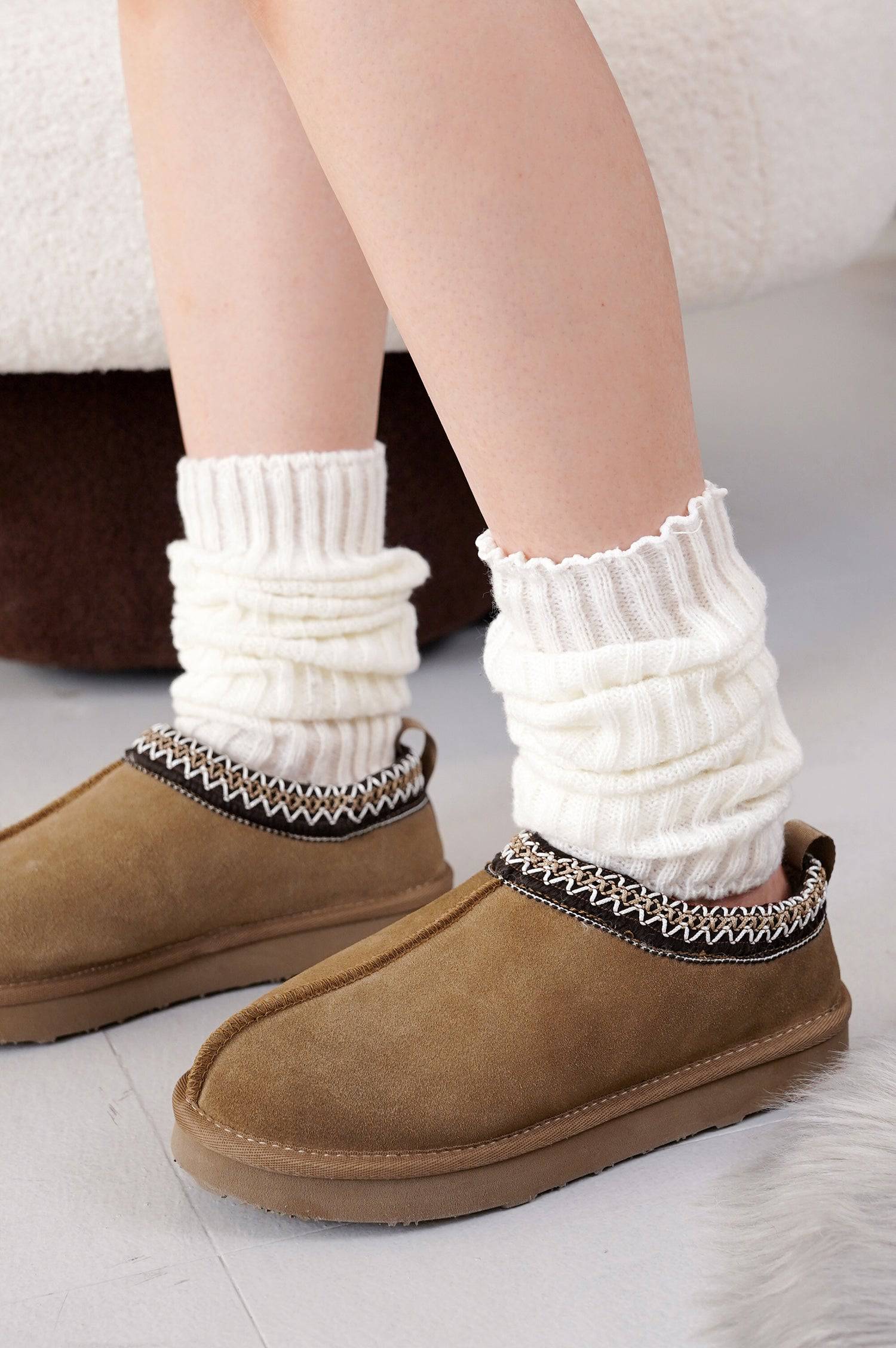 Project Cloud Nerita Slipper in brown, paired with off-white leg warmers, showcasing sheepskin fur and decorative trim.