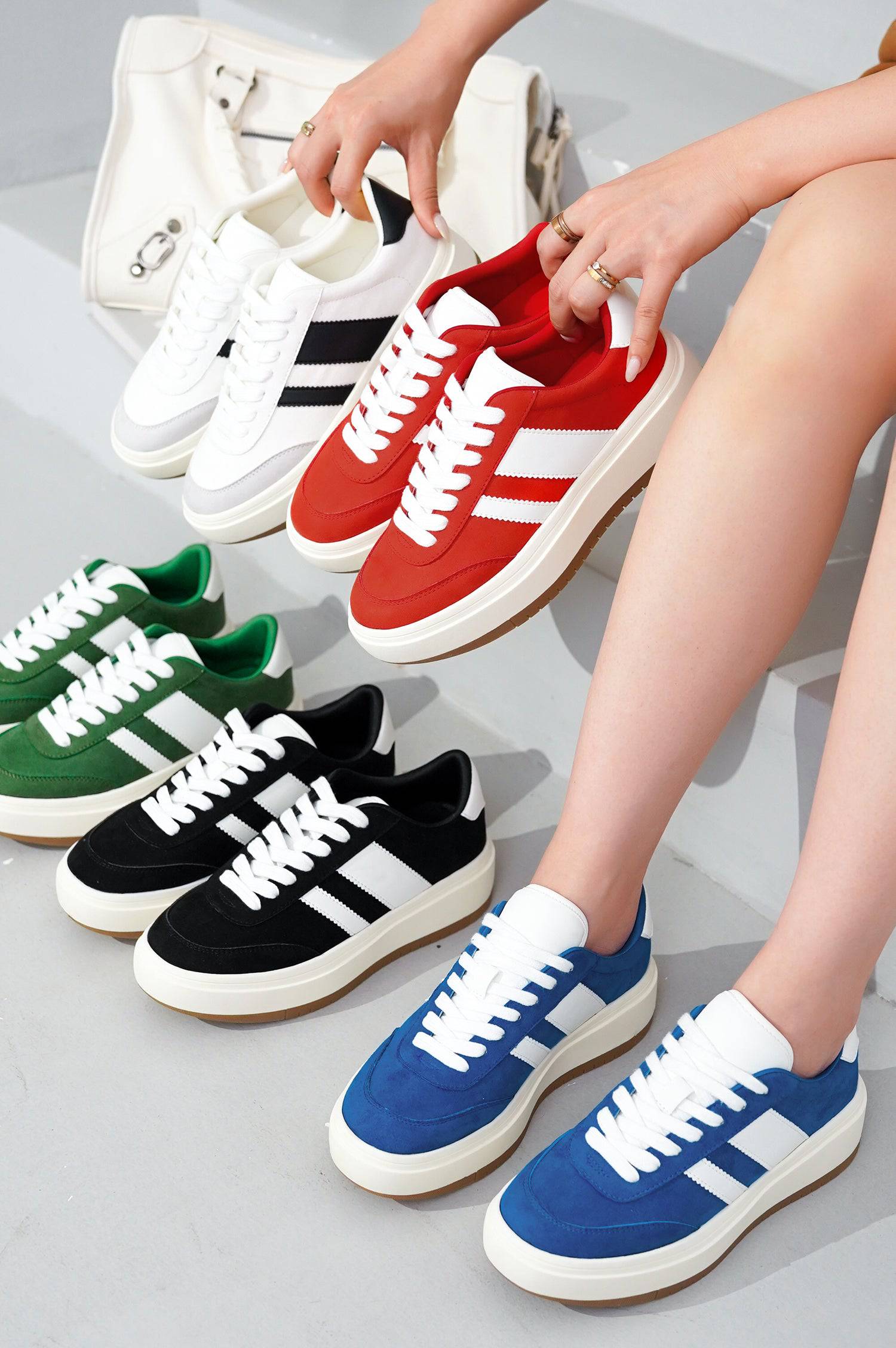 Nita platform sneakers in multiple colors. White stripes on suede, lace-up style, cushioned insole for women's comfort.