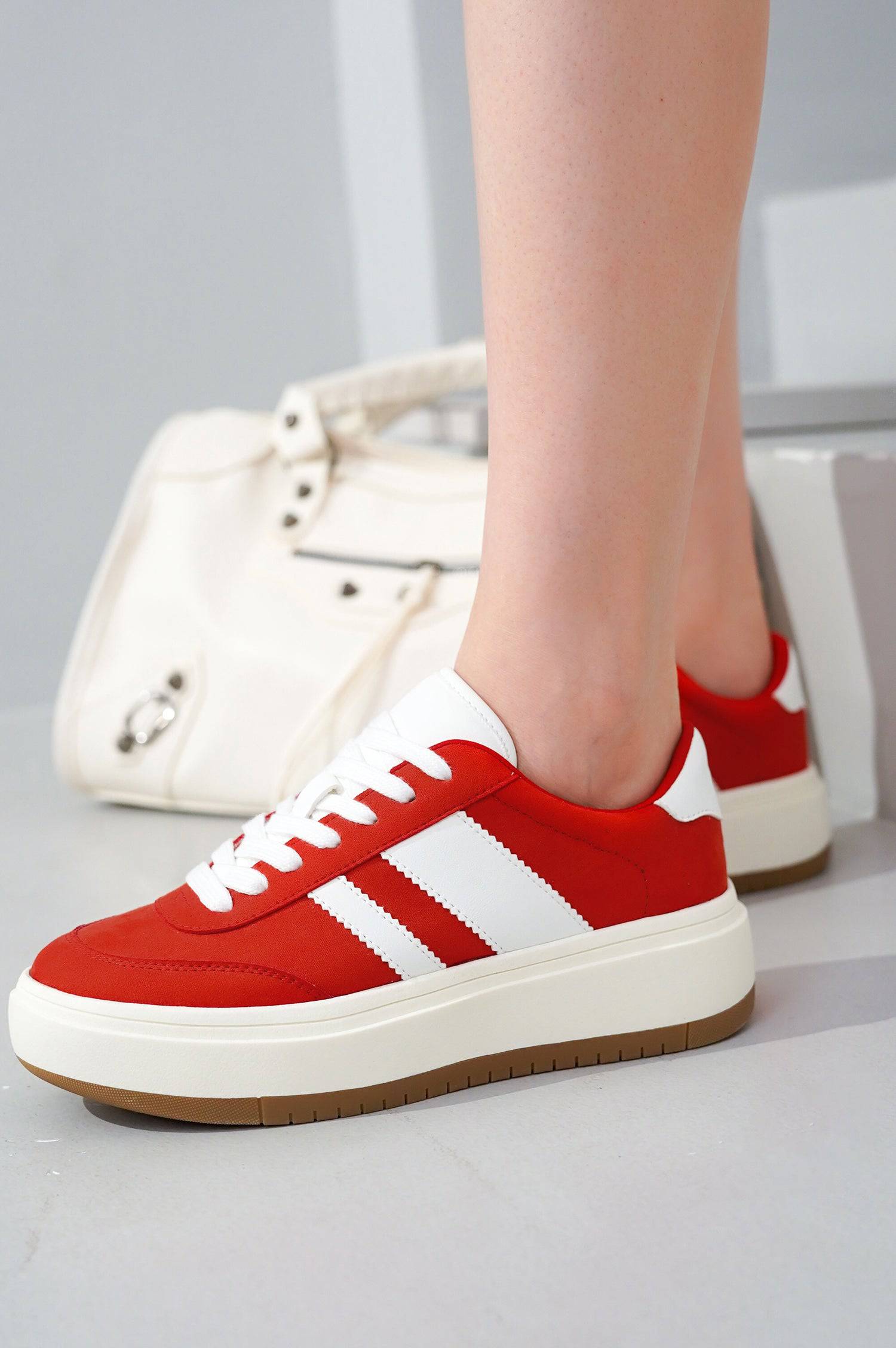 Red Nita platform sneakers with white stripes and laces. Women's lace-up fashion sneakers with cushioned insole for comfort.