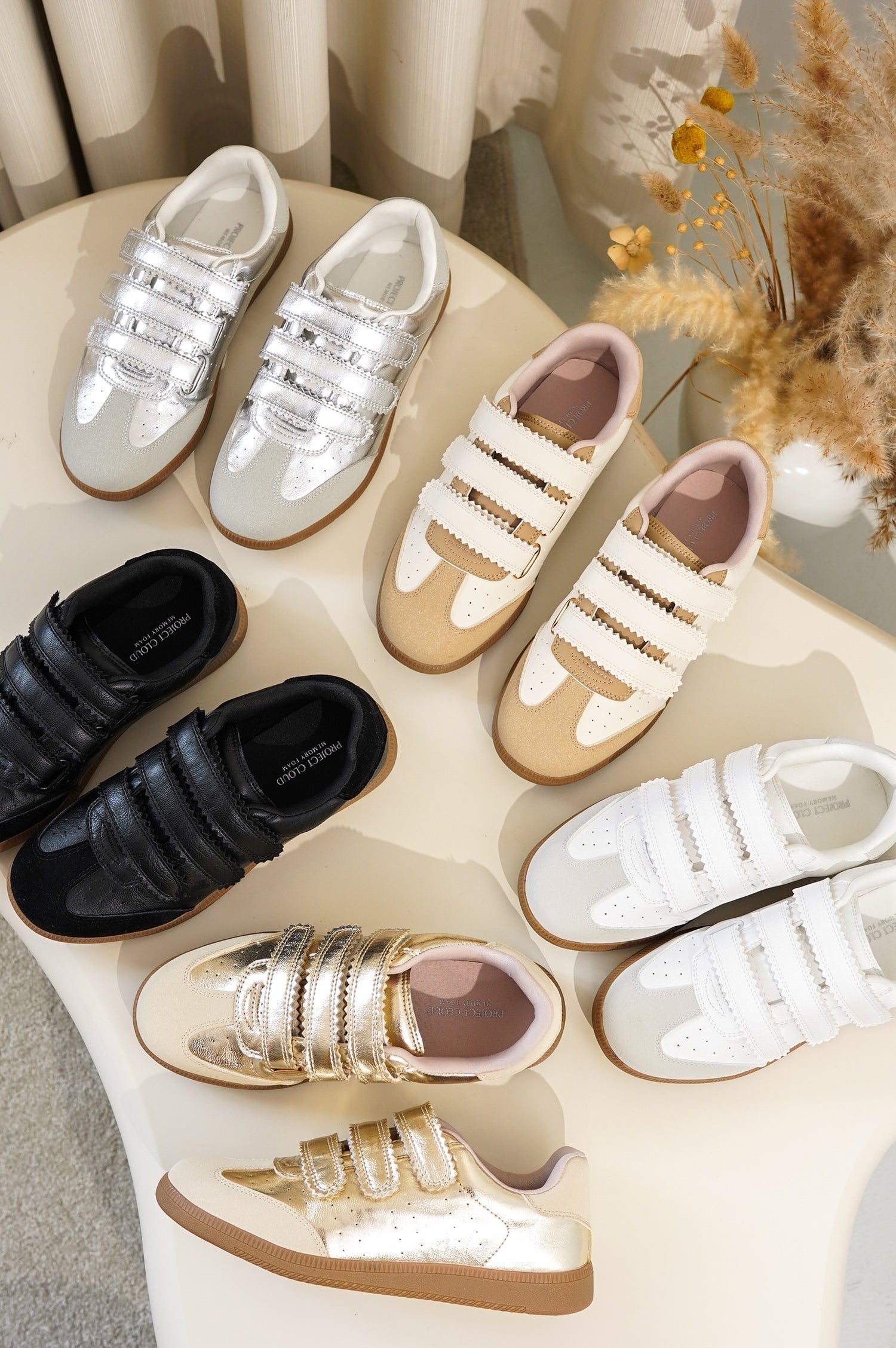 Project Cloud Ysabelle sneakers in gold, silver, white, black, and cream. Vegan leather, velcro straps, memory foam.