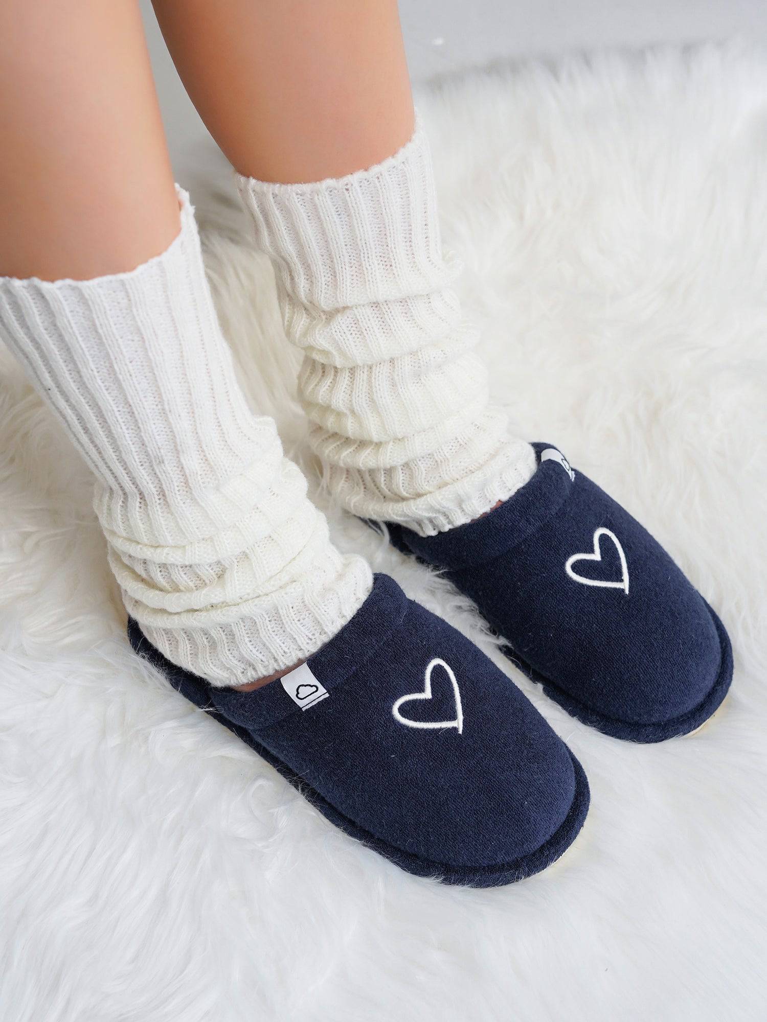 Project Cloud Casa navy memory foam slippers with white heart detail and white leg warmers, cozy footwear.