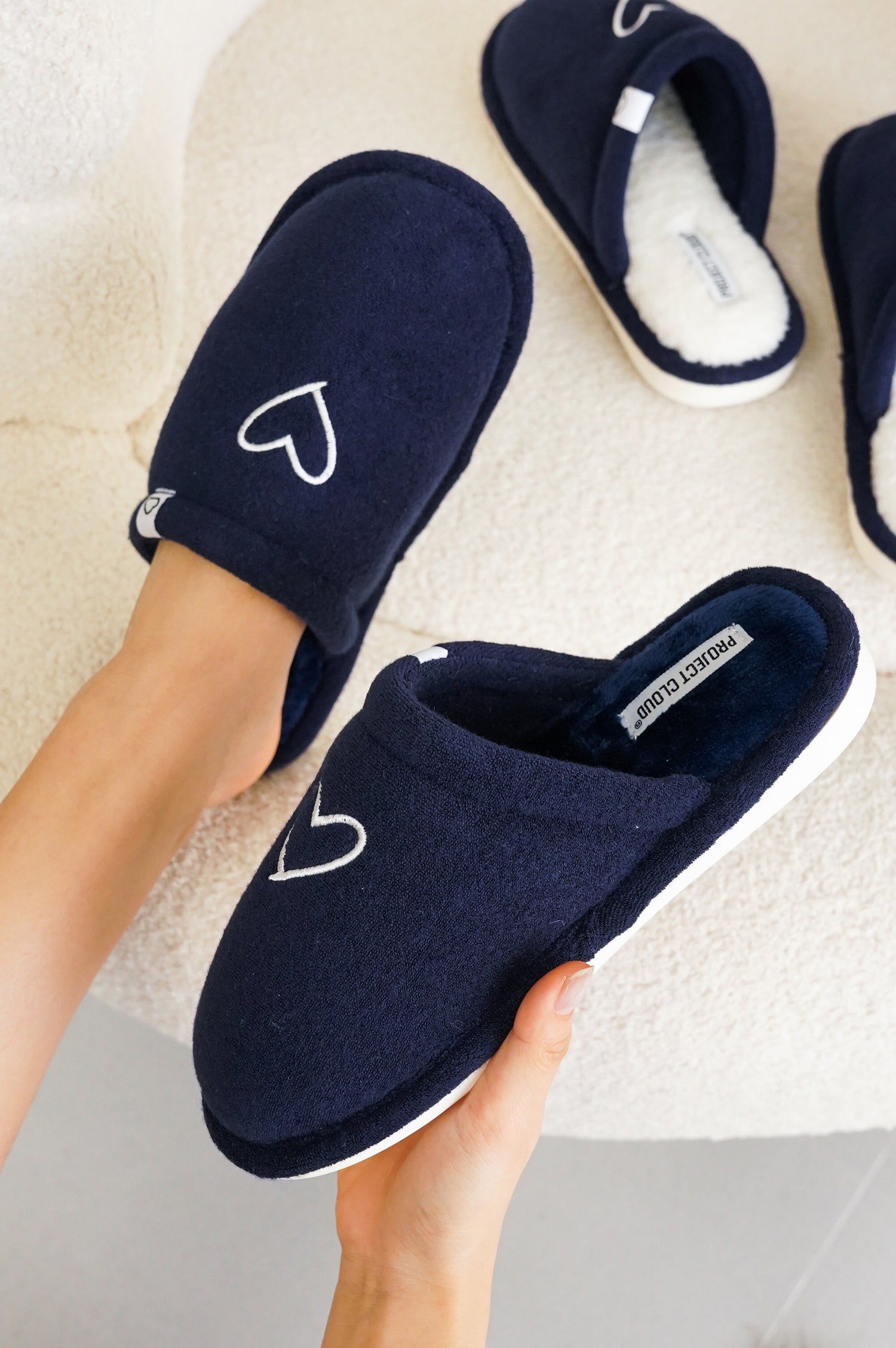 Project Cloud Casa women's navy memory foam slipper with heart detail. Featuring memory foam, non-slip sole, and cozy design.