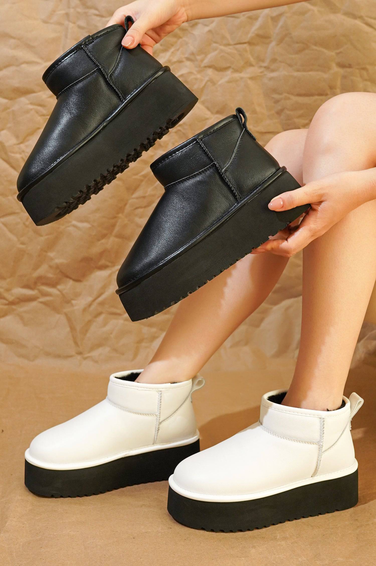 Black and white Huggy ankle boots, platform sole, faux fur lining. Lightweight Project Cloud winter boots.