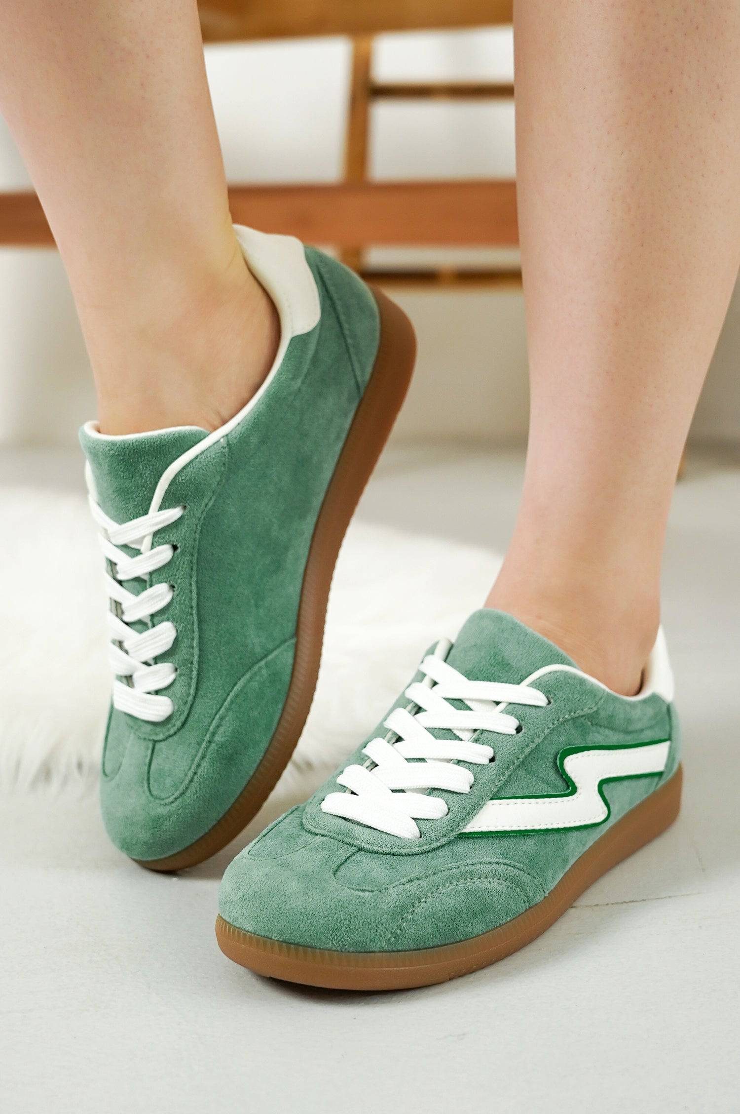 Project Cloud Irita women's green suede sneakers with white accents and brown sole. Lace-up style.
