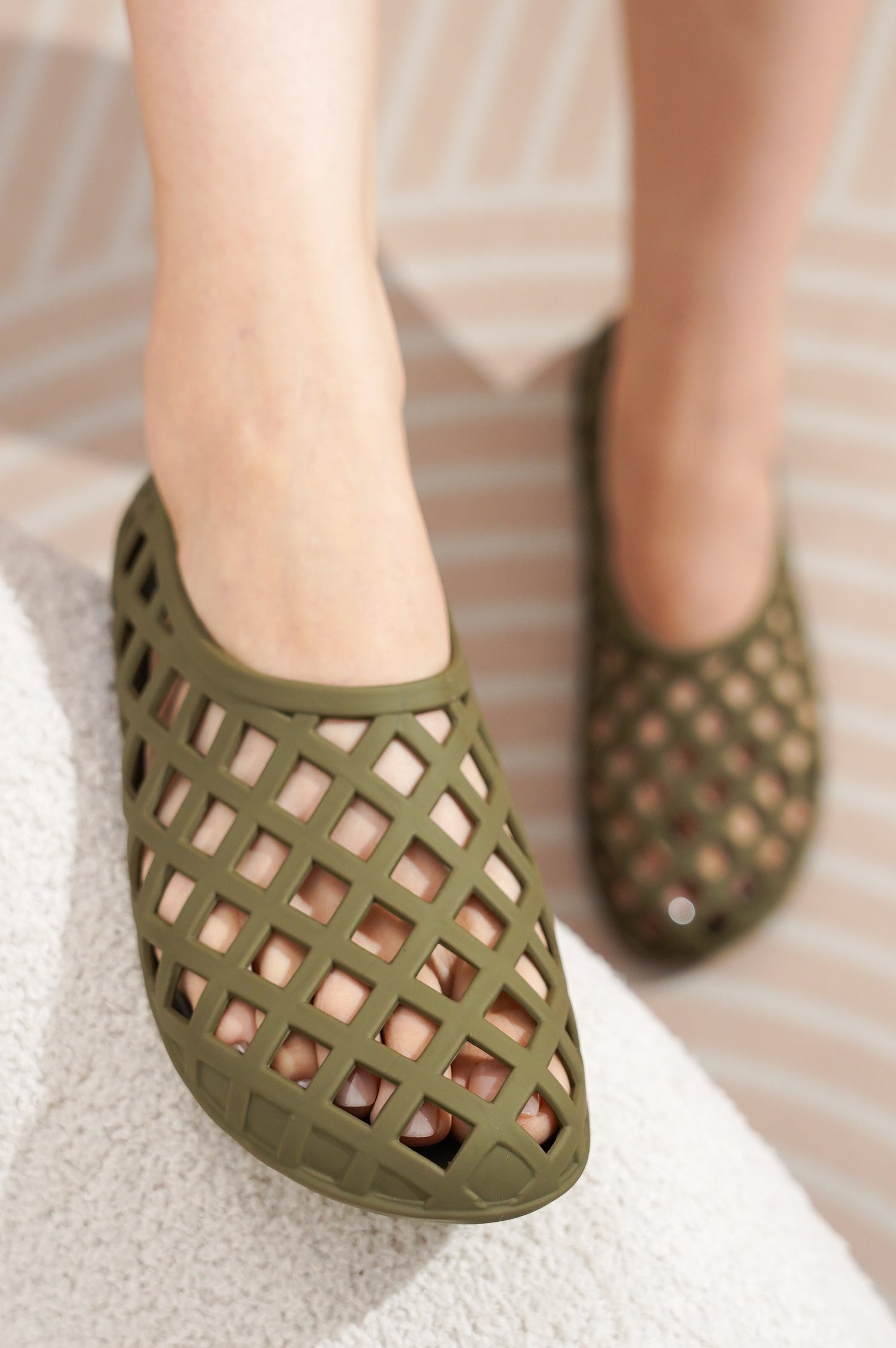 Olive green Jellz ballet flats with openwork design, waterproof and non-slip, on feet.