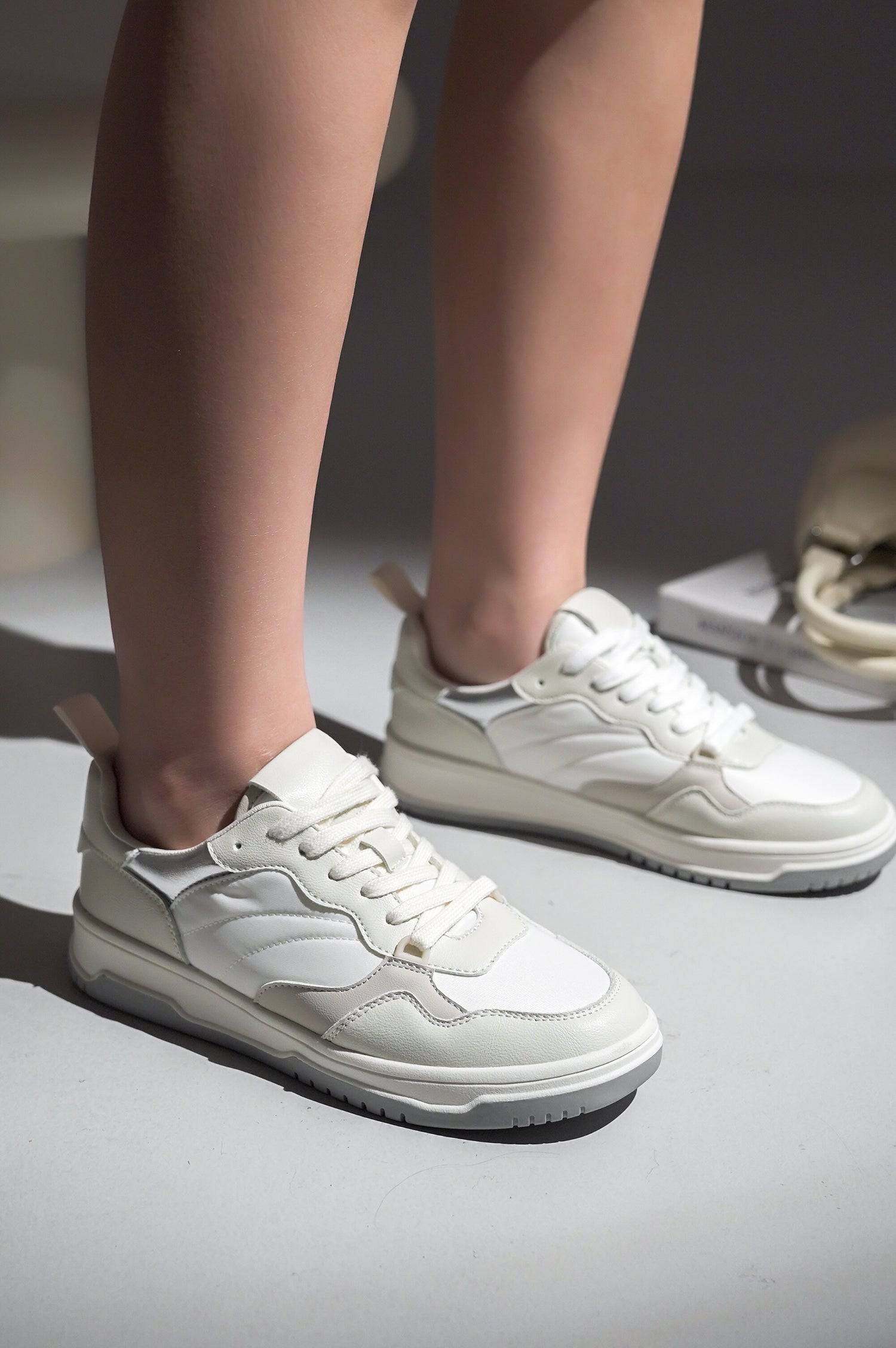 Women's white vegan leather Kiki sneakers, lace-up design, Project Cloud footwear, comfortable and stylish.