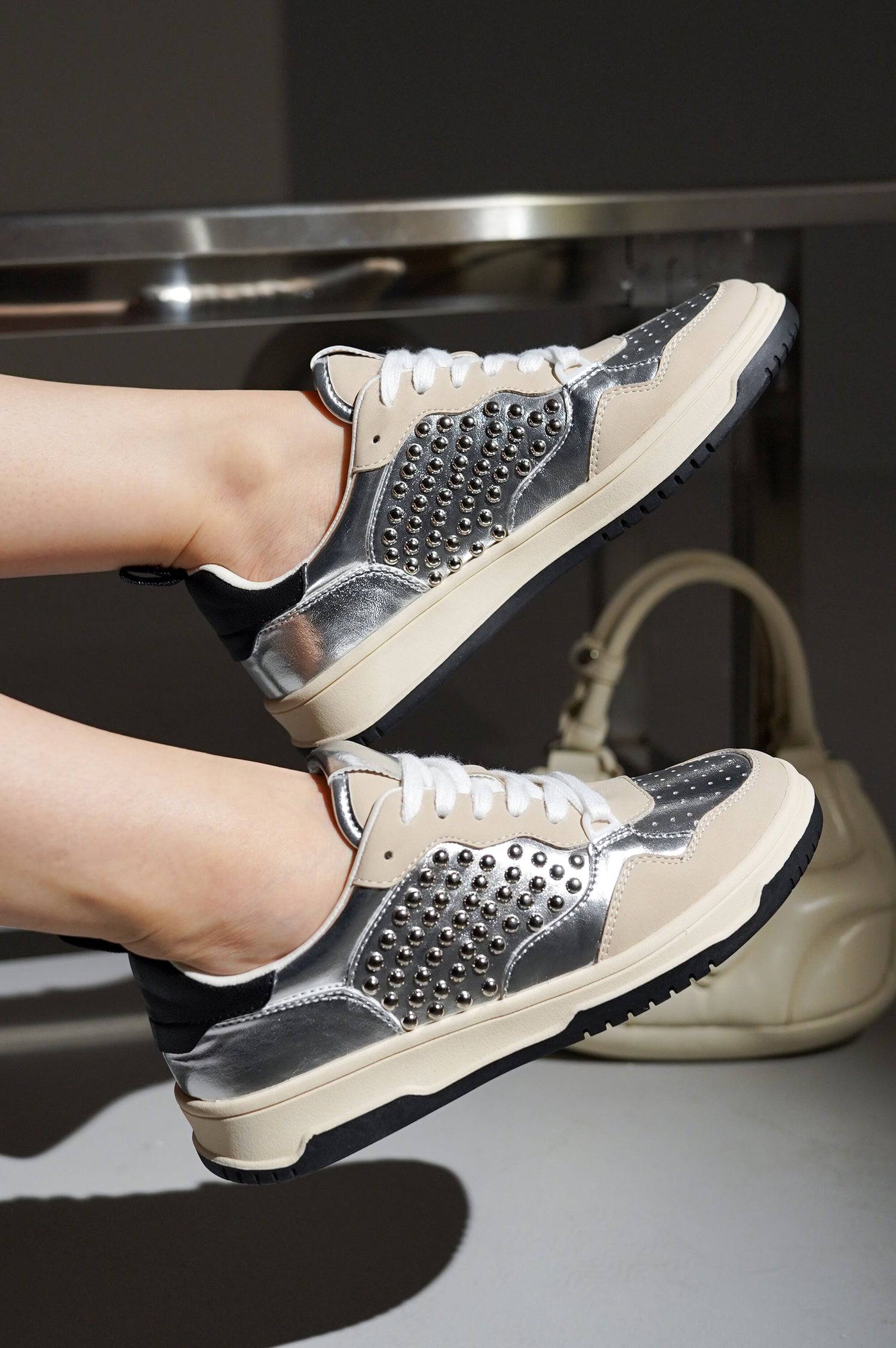 Silver-studded Kiki sneakers with metallic accents, showcasing women's fashion sneakers.