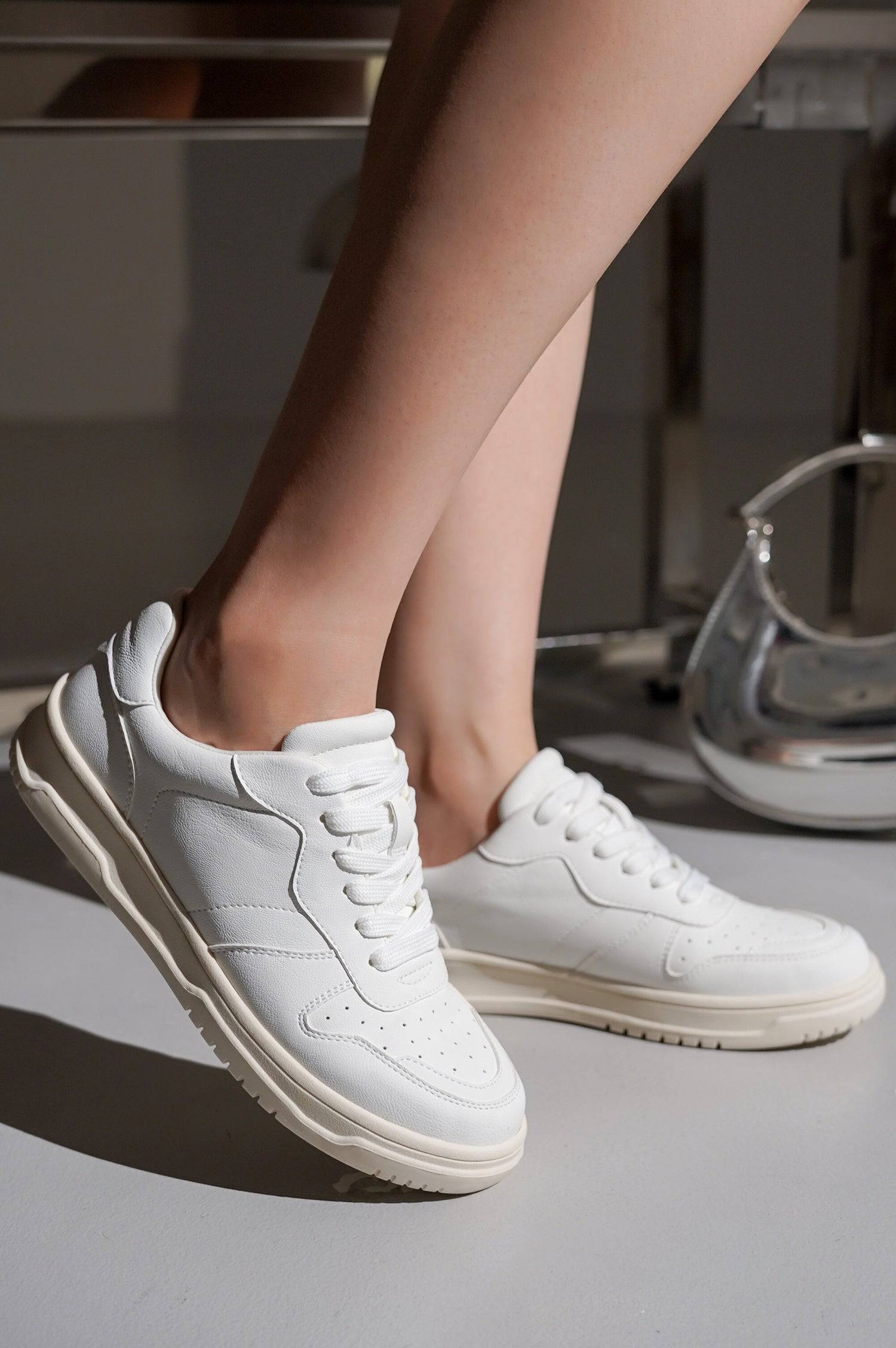 Women's white vegan leather Kiki sneakers, lace-up design, comfortable and stylish footwear.