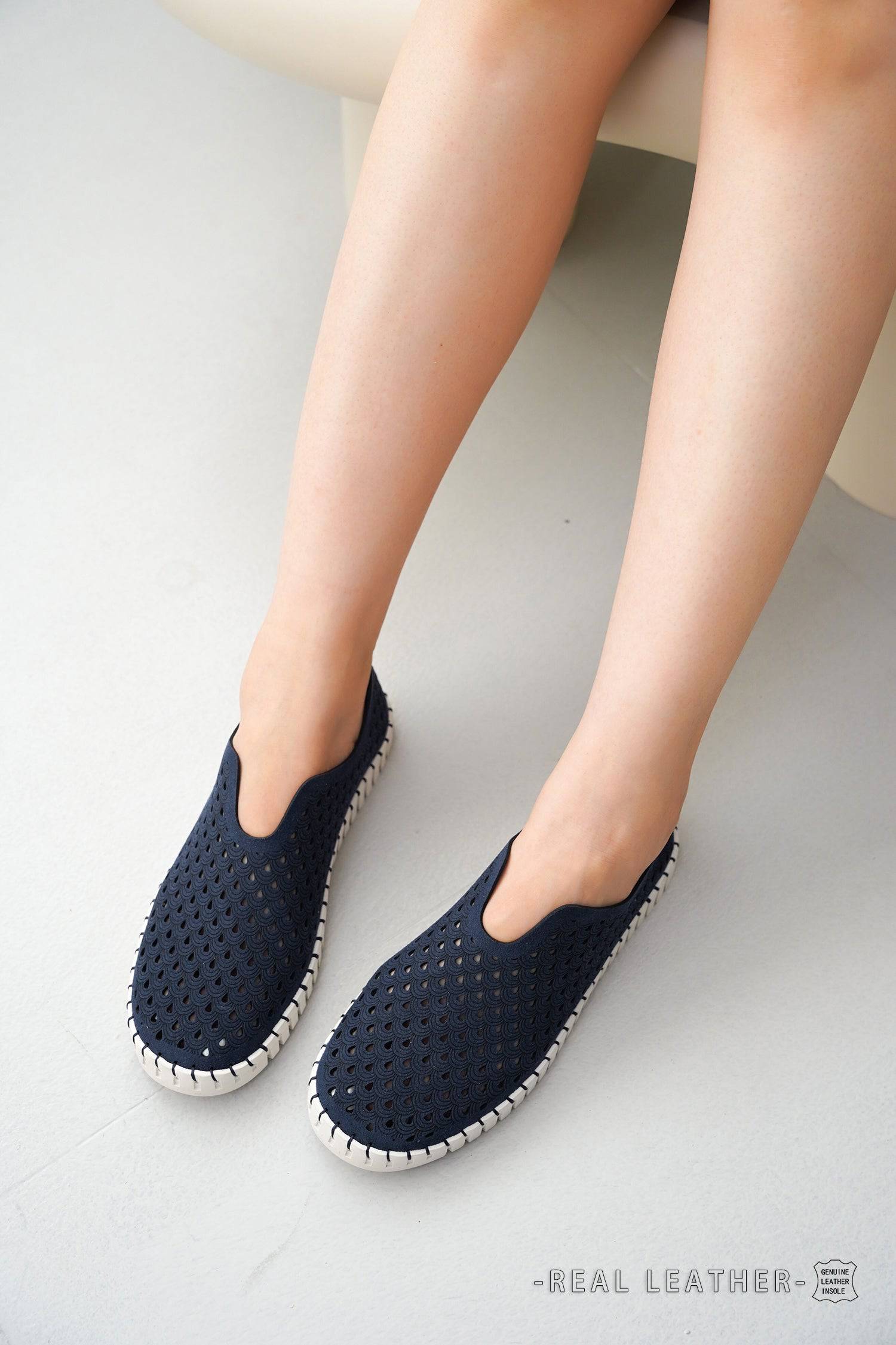 Perforated navy blue slip-on women's loafers with leather insole, lightweight flats.