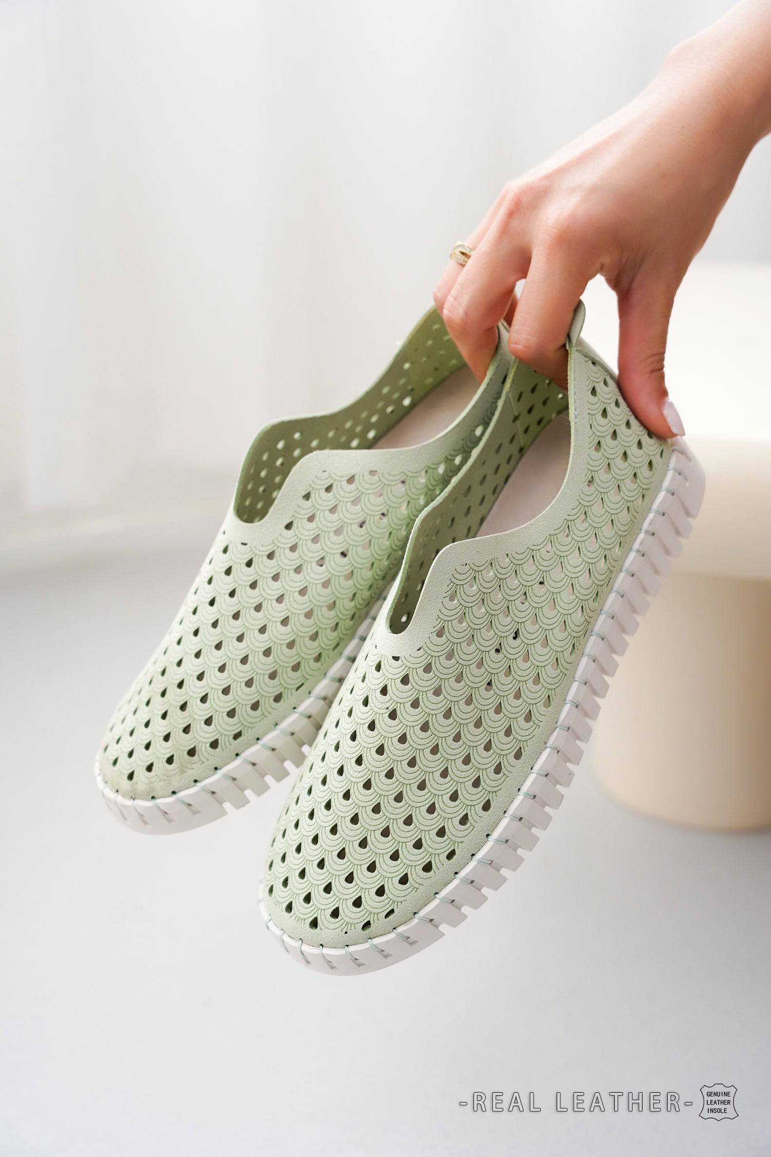 Green slip-on loafers for women with scalloped design, real leather insole, white sole.