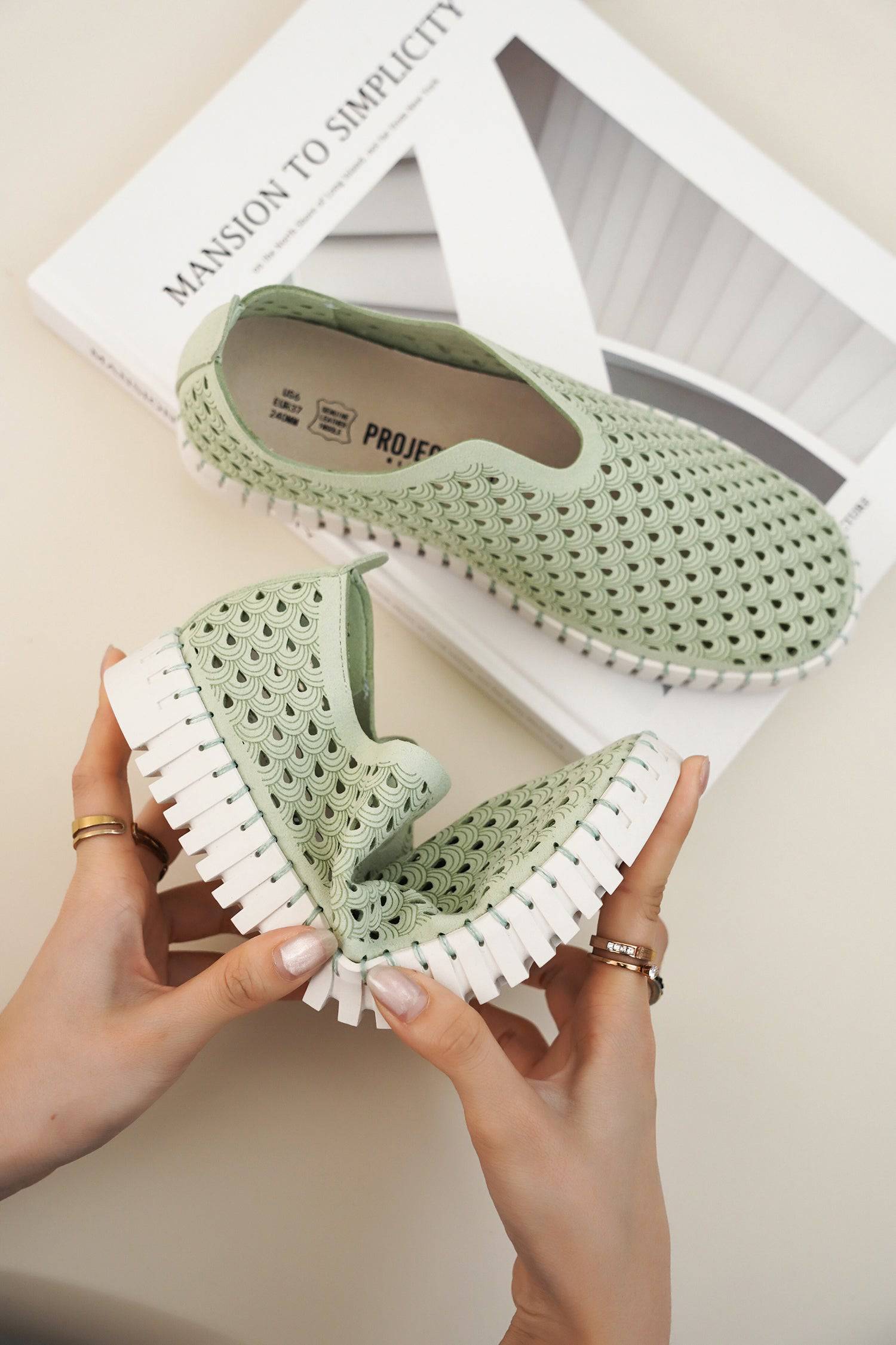 Perforated light green Lily loafers for women, white sole. Lightweight, comfortable slip-ons.