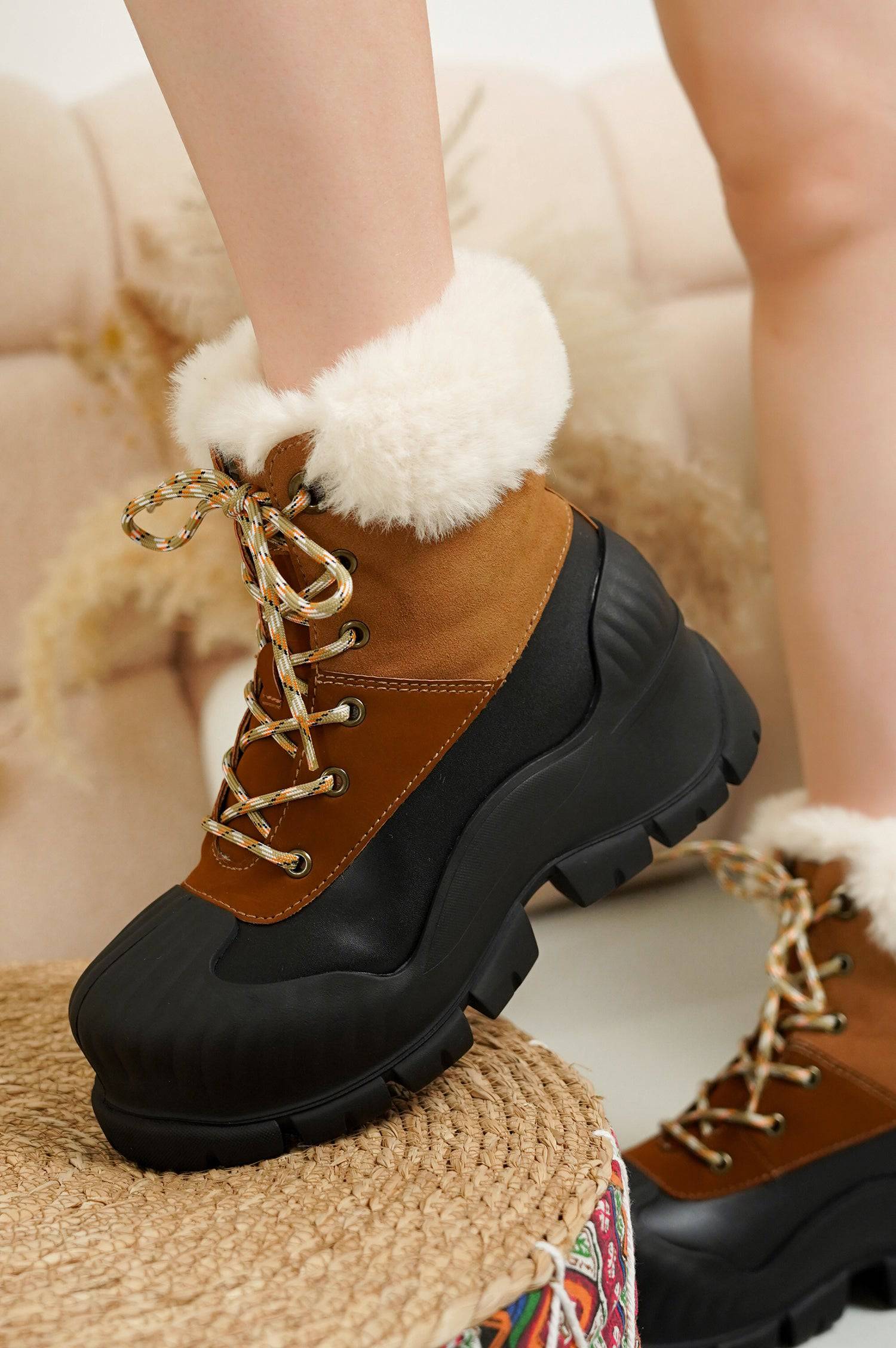 Project Cloud Lydia Winter Boots in brown and black, with faux fur trim and waterproof design. Lace-up detail.