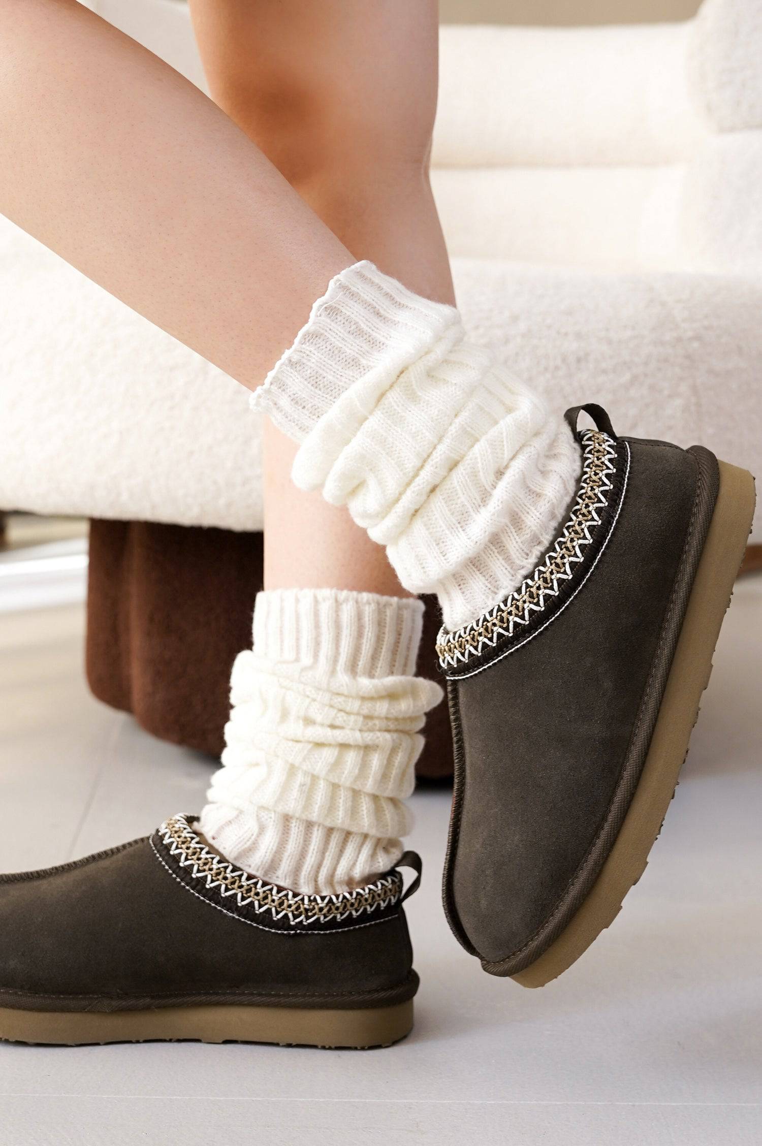 Project Cloud Nerita Slipper in Brown, paired with off-white leg warmers, showcasing sheepskin fur and decorative trim.