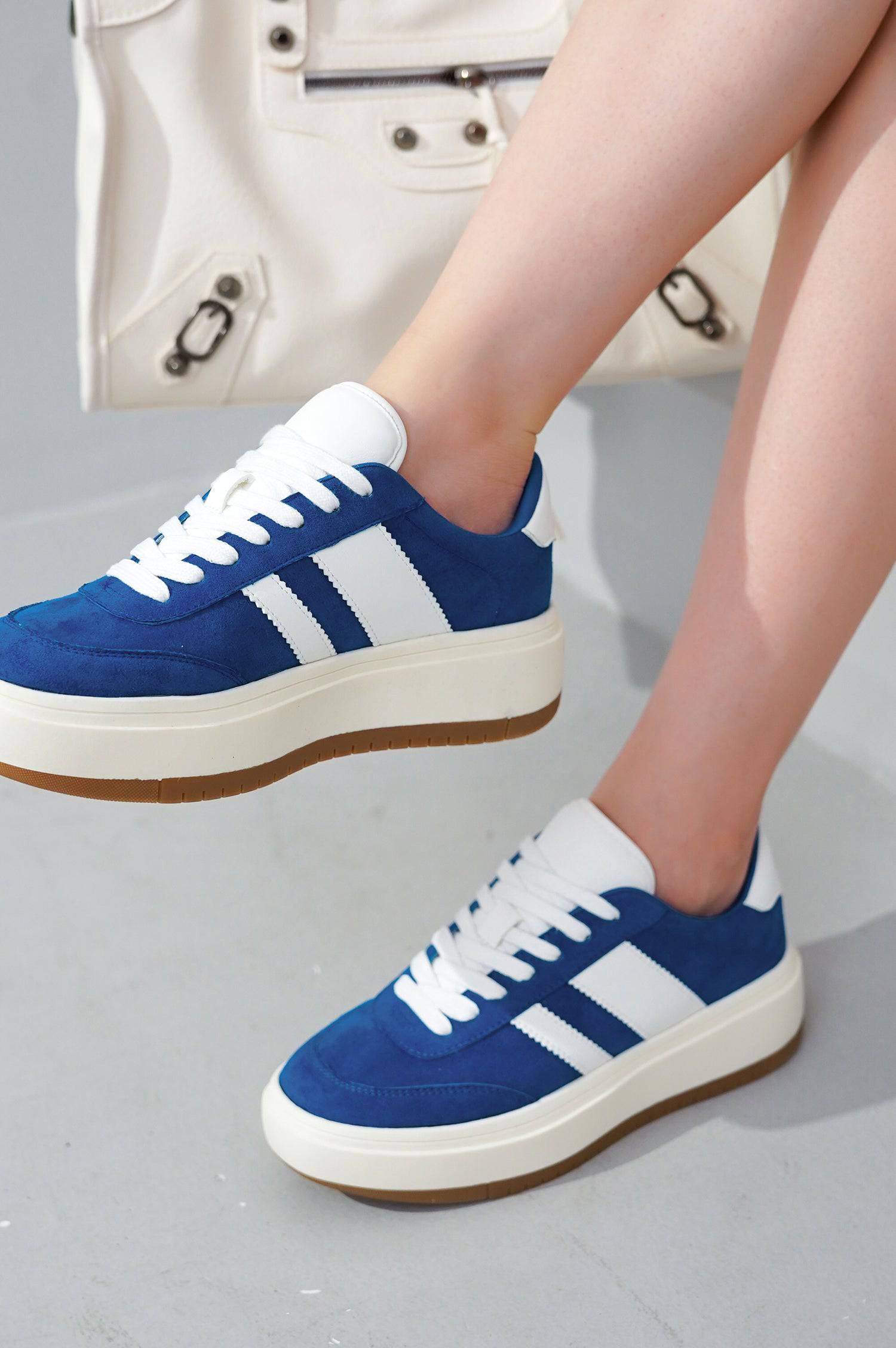 Blue Nita platform sneakers with white stripes, suede, lace-up, and cushioned insole for women's daily wear.