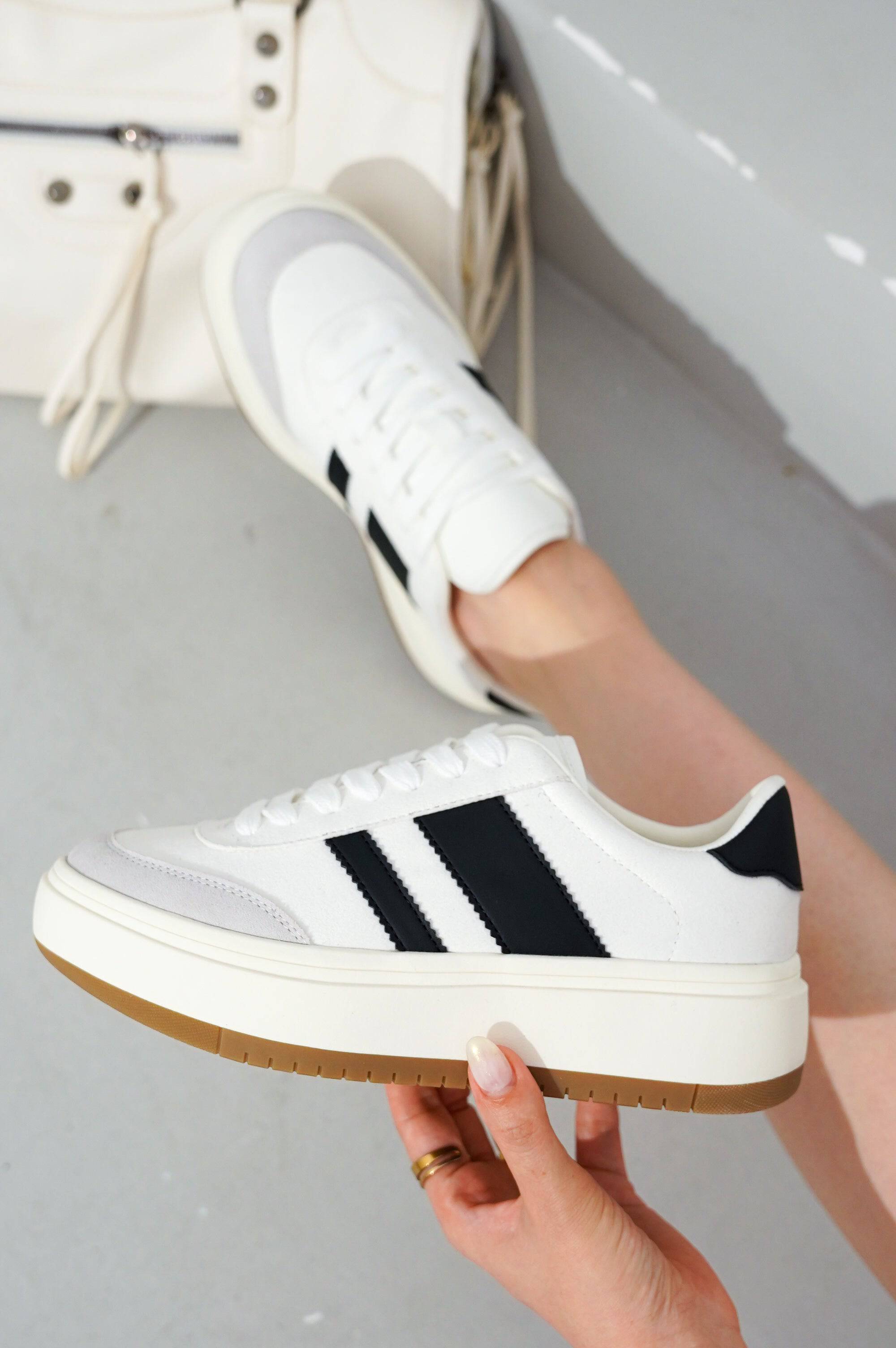 White Nita platform sneakers with black stripes, a beige sole, and lace-up design; Project Cloud women's fashion.