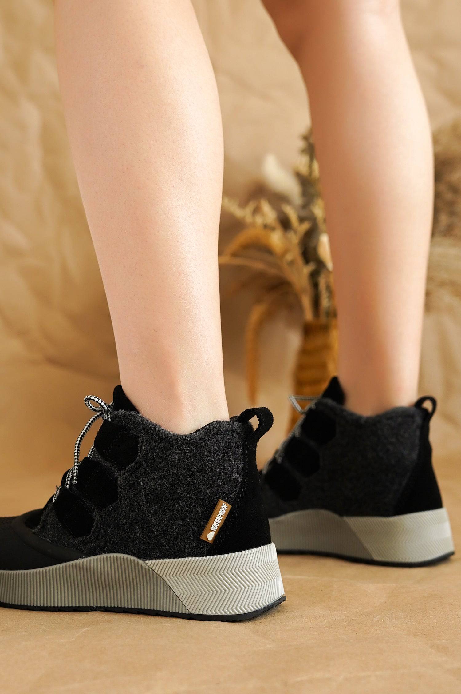 Project Cloud Rhianon women's waterproof snow boots. Black suede and gray felt upper, non-slip sole. 'Waterproof' label.