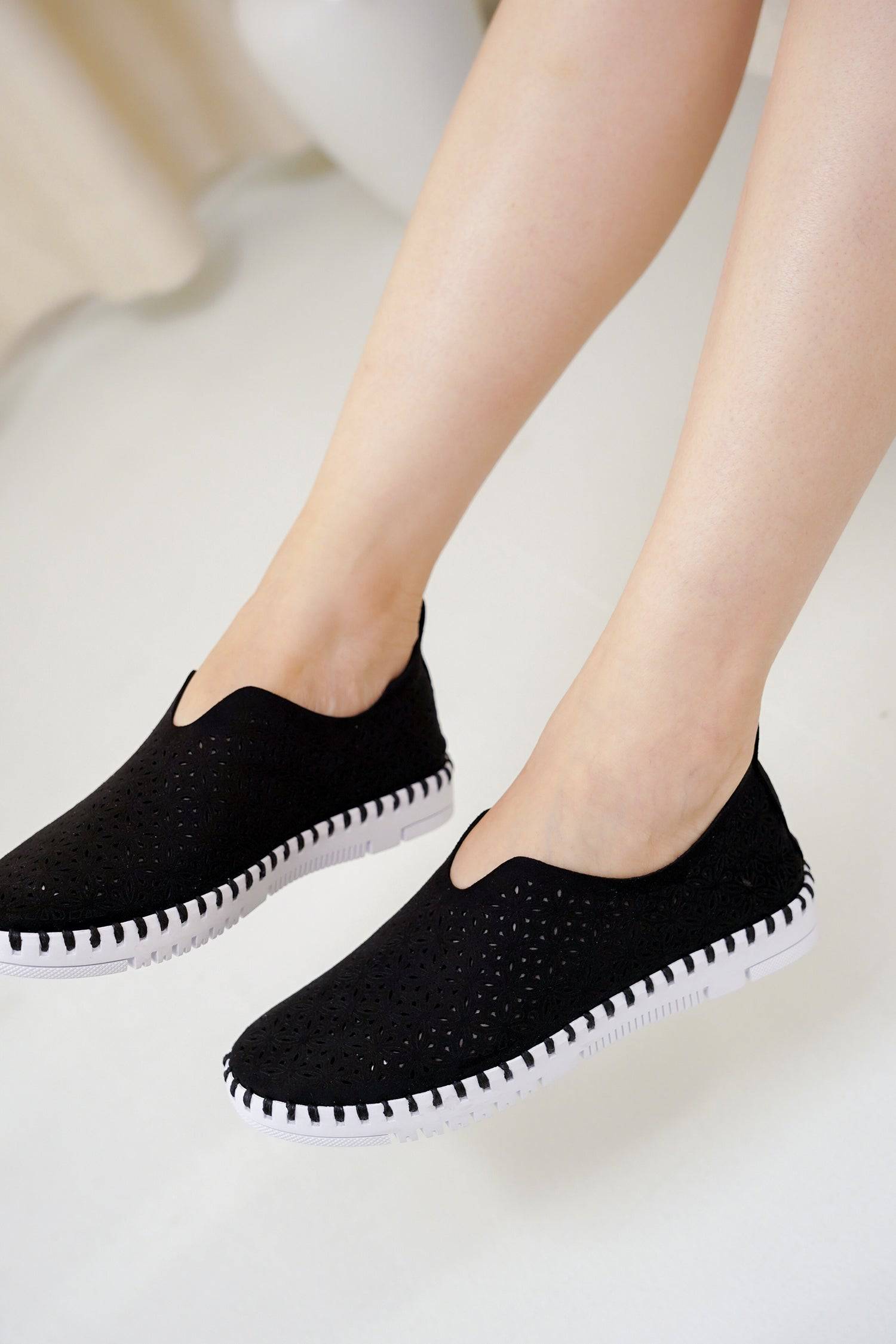 Black slip-on sneakers for women. Lightweight loafers, memory foam insole, and flexible outsole.